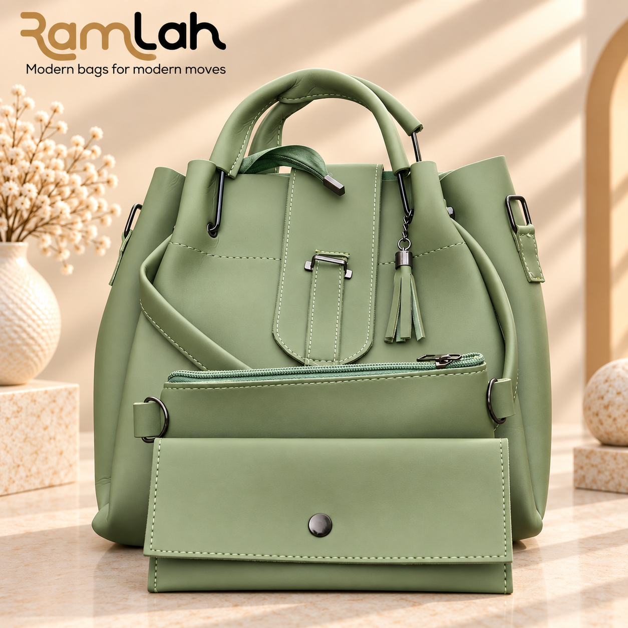 Sage green handbag with top handles, detachable shoulder strap, and tassel detail. Sage green handbag with top handles and a detachable shoulder strap