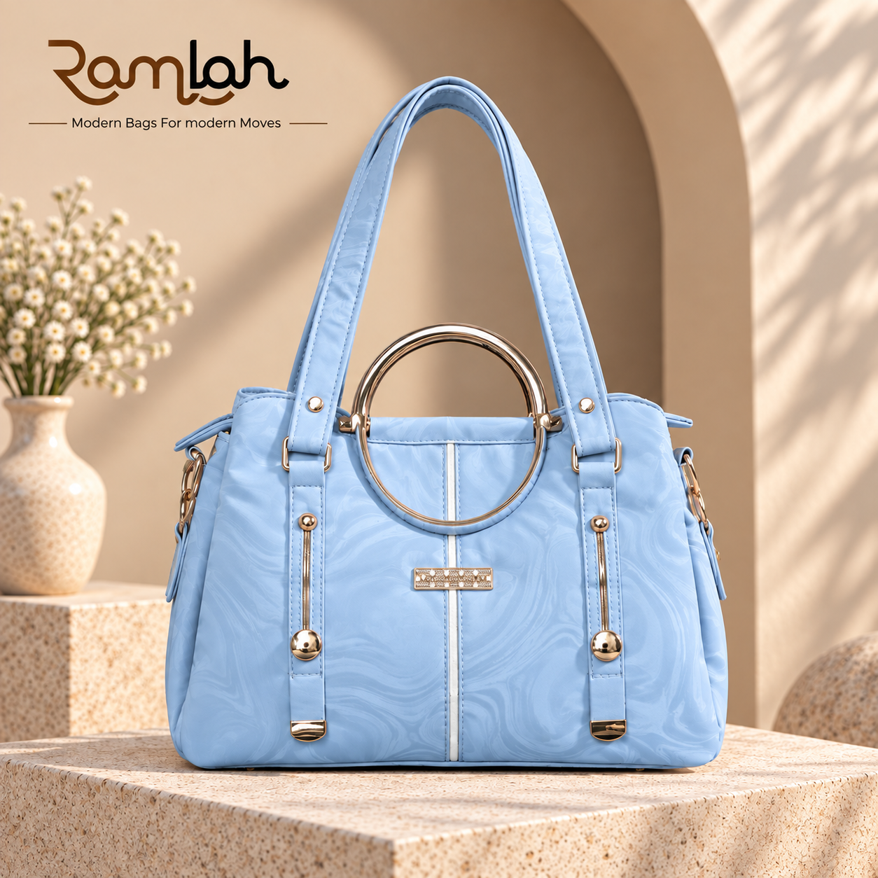 Marble Luxe Shoulder Bag for women in sky blue with a marble pattern, circular metal handle detail, and gold-tone hardware